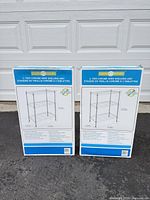 Two boxed Organize Everyday 3-tier chrome shelving units front view