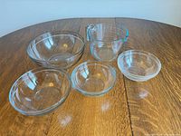 All five clear glass pieces displayed on table
