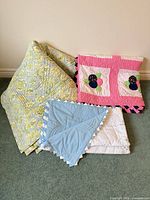 Three folded quilts showing colours and patterns