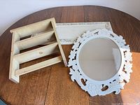 Mirror, shelf, plaque grouped on table