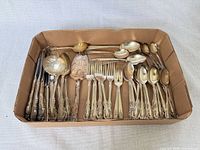 Tray of assorted silverplate flatware showing overall quantity and pattern