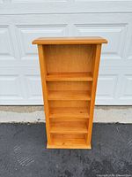 Front view of solid pine bookshelf showing five shelves