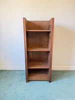 front view showing four open shelves and overall form