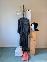 Overall view of black dress, bonnet, nurses cap, aprons