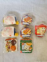 All seven Fisher-Price Fun With Food McDonald’s play food sets grouped on surface