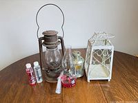 Group shot of all lanterns, oil lamp, fuel bottles and accessories on table