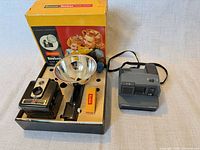 Entire lot showing Kodak Brownie Hawkeye Flash Outfit boxed set with reflector and Polaroid Impulse camera