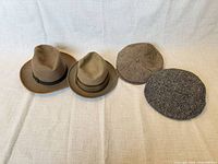 Four hats laid flat showing overall styles and colours