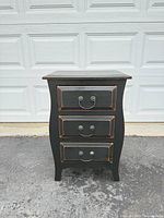 Full view of nightstand front against garage door backdrop