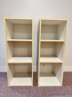 Front view of the two bookshelves showing shelves and beige trim