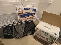 Both mattress boxes with folded/deflated mattress and storage bag