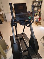 Front view showing console, handlebars, pedals and frame