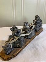Full view of entire dog sled figurine on base