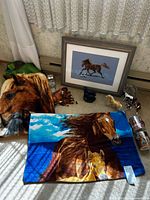 Group shot of all items: throws, framed cross-stitch, figurines, mugs