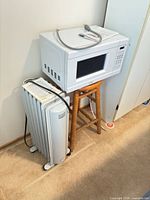 Microwave atop heater showing both items