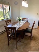 Dining table with four chairs in room setting