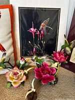 Close-up of black-background hummingbird print and surrounding porcelain hummingbird figurines