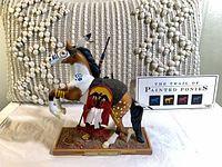 Left side profile of War Cry figurine on base with Painted Ponies card visible