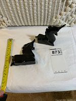 Figurines with tape measure indicating size and lot tag