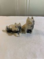Front view of both dog figurines showing colour and posture