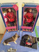 Group shot of two boxed Barbie dolls, resin dog, resin horse, and pewter miniatures