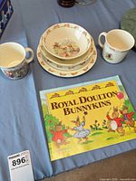 Dinnerware pieces and book arranged on table