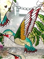 Close-up of hummingbird and foliage detail on stained glass