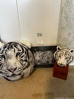Overview with plush tiger pillow, framed photo, bust sculpture