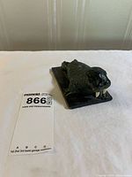 Top view of Wolf Original soapstone walrus showing overall form and tusks beside scale card