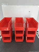 three stacks of red AkroBins showing quantity and condition