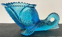 Left profile of blue pressed glass fish candy dish