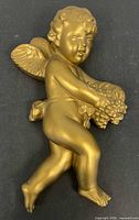 Front view of gold cherub wall hanging