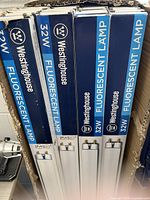 Stack of Westinghouse 32 W fluorescent lamp boxes