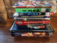 Entire stack of eight books side view showing spines and titles