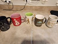 All five mugs side by side on countertop