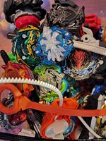 Close-up of assorted Beyblade Burst tops showing colours and metal discs