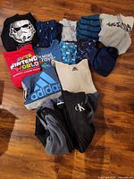 Overview of entire clothing lot laid out on floor