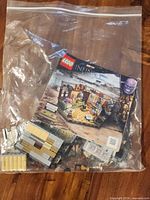 Bag containing loose LEGO pieces and instruction booklet