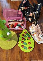All items together: scratching post, carrier, puzzle feeder, toy bin, recovery PJs