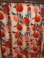Peach fruit motif shower curtain hanging from rings