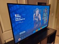 TV powered on showing NBA game via Fire TV interface