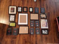 All twenty black frames laid out on floor showing variety