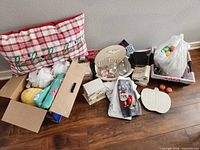 Group shot showing pillow, baskets, boxes, ornaments, wood sign, bag of eggs