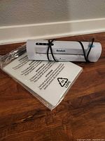 Scotch laminator with sealed pack of laminating sheets on wood floor