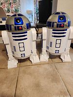 Two R2-D2 popcorn buckets front view
