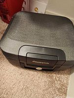 Closed SentrySafe chest top view, showing textured lid and handle