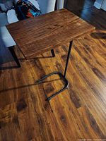 Full view of sofa side table showing wood top and metal base