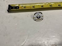 Top view showing full Buffalo Sabres jersey pin next to tape measure