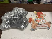 Top view of aluminum carousel horse cake pan and cardboard insert