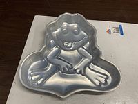 Top view of entire frog-shaped cake pan showing mold details and overall condition
